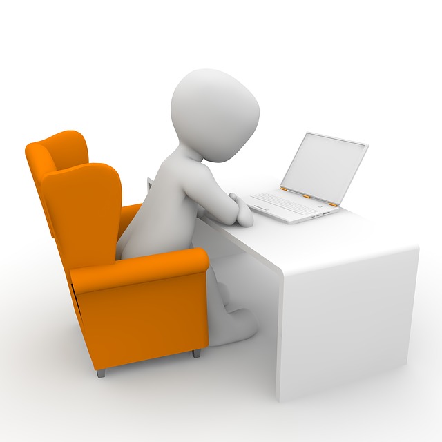 This is a graphic of a round character sitting at a desk typing on a laptop.