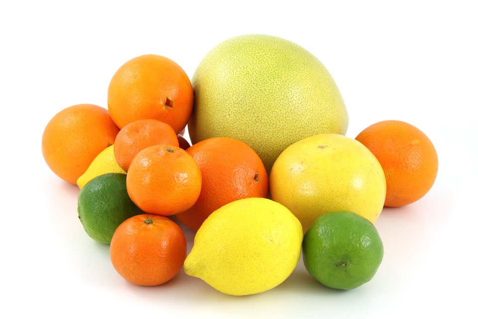 This is an image of a pile of citrus fruit including lemons, limes, oranges and a grapefruit.