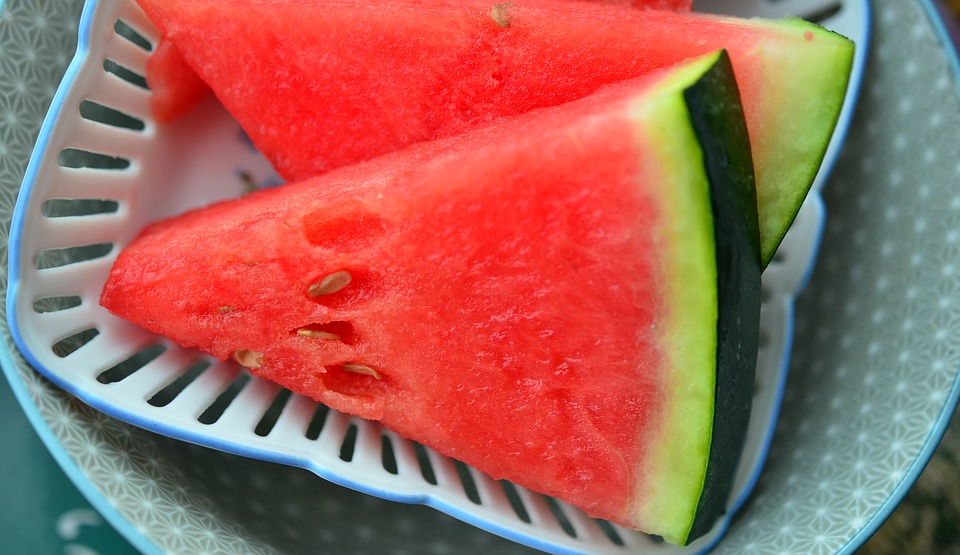 This is an image of two watermelon slices on a plate.